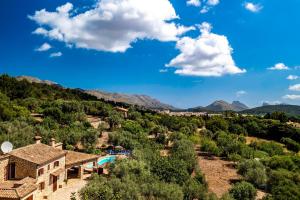 a view of a resort with a pool and mountains at Villa Alordes in Pollença