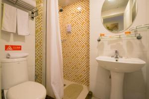 a bathroom with a toilet and a sink and a mirror at Home Inn Shijiazhuang West Zhongshan Road Jinding Apartment in Shijiazhuang