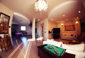 a living room with a couch and a table with a foos ball at Oasi Brembate Bed and Breakfast in Brembate