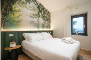 a bedroom with a bed and a large painting on the wall at Lumamè Resort B&B in Montefiore Conca