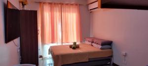 a small bed with a teddy bear sitting on it in a bedroom at At LBS 888 Condo Unit Rental-Full Relaxing Seaview 304-10Flr in Lapu Lapu City +14 photos