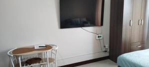 a room with a tv and a table with cookies on it at LBS Condo Rental-Full Relaxing Seaview 304-10Flr in Lapu Lapu City