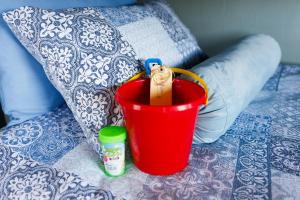 a red bucket sitting on top of a bed at Reebok Rest in Reebok +79 photos