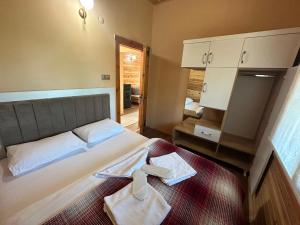 a bedroom with a bed with two towels on it at SultanMurat-Otel-Görnek Tabiat Parkı in Trabzon +39 photos