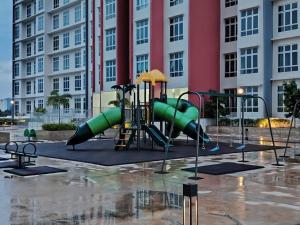 a playground in front of a large building at AzzSpacesAnderson in Ipoh