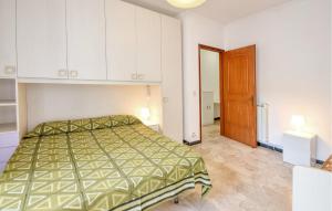 a bedroom with a bed and a wooden door at 2 Bedroom Lovely Apartment In Moneglia in Moneglia