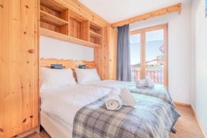 a bedroom with two beds and a window at Pracondu 2 305 - OUTDOOR & FUN charming apartment in Nendaz +162 photos