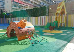 a playground with a park with a bench and a swing at Port Benidorm Hotel & Spa 4* Sup in Benidorm