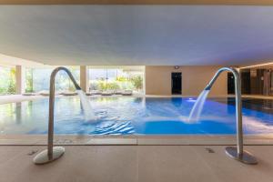 a large swimming pool with two water jets at Port Benidorm Hotel & Spa 4* Sup in Benidorm
