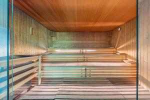 a sauna with wooden walls and a wooden ceiling at Port Benidorm Hotel & Spa 4* Sup in Benidorm