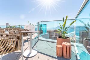 a balcony with a table and a potted plant at Port Benidorm Hotel & Spa 4* Sup in Benidorm