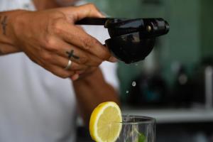 a person is juicing a lemon with a juicer at Port Benidorm Hotel & Spa 4* Sup in Benidorm