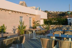 a restaurant with tables and chairs on a roof at Port Benidorm Hotel & Spa 4* Sup in Benidorm