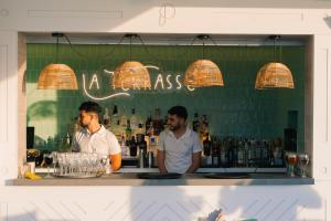 two men standing at a bar in a restaurant at Port Benidorm Hotel & Spa 4* Sup in Benidorm