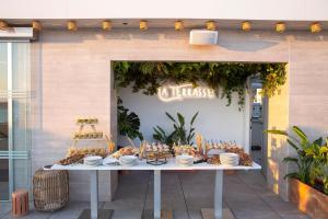 a table with bowls and plates on top of it at Port Benidorm Hotel & Spa 4* Sup in Benidorm