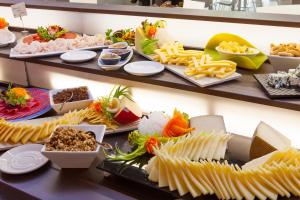 a buffet filled with different types of food on shelves at Port Benidorm Hotel & Spa 4* Sup in Benidorm