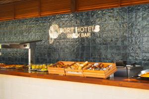 a counter with a buffet of food in a restaurant at Port Denia in Denia