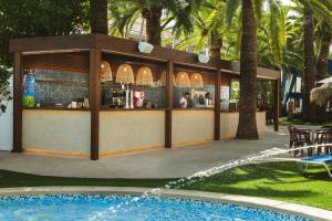 a restaurant with a bar next to a swimming pool at Port Denia in Denia