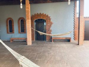 a patio with a hammock in a building at LINDA CASA A 500mts da PRAIA DE CIBRATEL PARA CURTIR COM AMIGOS E FAMILIA in Itanhaém