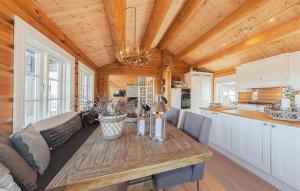 a kitchen and living room with a wooden ceiling at Stunninng Home In Rauland With Sauna in Rauland