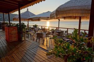 a restaurant on the beach with tables and chairs at saracena Holiday Home with Private Beach and Swimming Pool in Mattinata