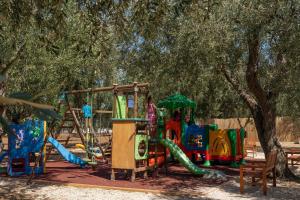 a park with a playground with a slide at saracena Holiday Home with Private Beach and Swimming Pool in Mattinata