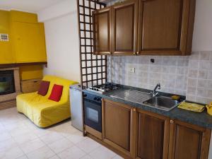a kitchen with a sink and a stove top oven at ski apartment in Ovindoli