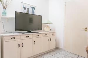 a living room with a tv on a white cabinet at Villa Cristina a marina di Capilungo - Apulia Home in Capilungo