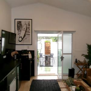 una cucina con porta che si apre su un patio con tavolo di Studio 34 - Nelson Bay a Nelson Bay