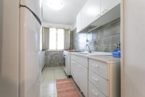 a kitchen with white cabinets and a sink at Villa Cristina a marina di Capilungo - Apulia Home in Capilungo +28 photos