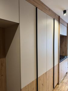 a wall of sliding glass doors in a hallway at Apartman A55 Aparthotel Vučko privatni apartman in Jahorina
