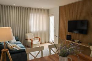 a living room with a couch and a table at Dunas Ria Apartment T2 in Gafanha da Encarnação