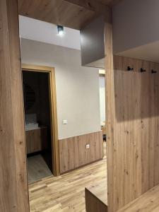 an empty room with wooden walls and a mirror at Apartman A55 Aparthotel Vučko privatni apartman in Jahorina +6 photos