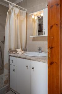 a bathroom with a white sink and a mirror at Villa Elizabeth in Symi +55 photos