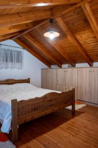 a bedroom with a large bed in a room with wooden ceilings at Villa Elizabeth in Symi +55 photos