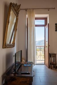 a room with a desk and a mirror and a door at Villa Elizabeth in Symi