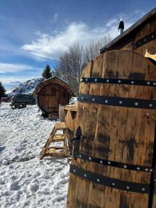 a pair of wooden wine barrels in the snow at Spiky hill resort in Kopaonik