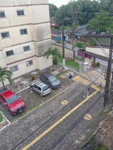 two cars parked in a parking lot next to a building at Apartamento cop in Ananindeua