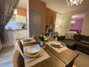 a dining room and living room with a table and chairs at Appartamento Chagall in Asti