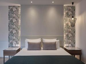 a bedroom with a large bed with two night stands at Atlantica Sungarden Park in Ayia Napa