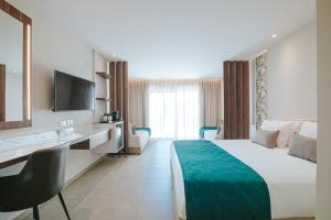 a hotel room with a bed and a desk at Atlantica Sungarden Park in Ayia Napa