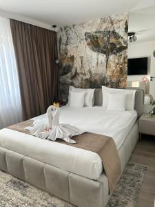 a bedroom with a large bed with a stuffed animal on it at Est One Apartament 2 camere semidecomandat in Drobeta-Turnu Severin