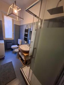 a bathroom with a shower and a sink and a toilet at Casa Nice - centro Bogliasco in Bogliasco +17 photos