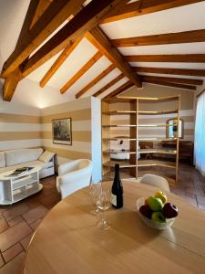 a living room with a table and a couch at Manci Apartments by Hotel America in Trento