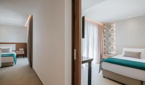 a hotel room with a bed and a window at Atlantica Sungarden Park in Ayia Napa
