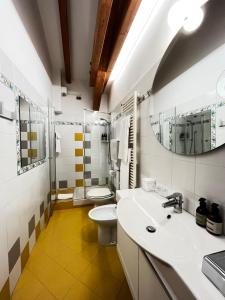 a bathroom with a sink and a toilet and a mirror at Manci Apartments by Hotel America in Trento +31 photos