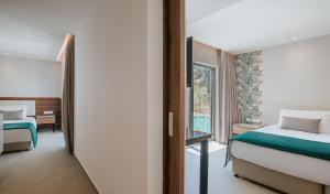 a hotel room with a bed and a window at Atlantica Sungarden Park in Ayia Napa