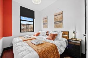 a bedroom with two beds and a window at Rustic Chic 4BR for Groups - Bushwick's Finest Stay in Brooklyn