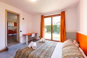 Postel nebo postele na pokoji v ubytování Spluga "Relax & Apartaments" by Alfio Colombo