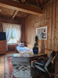 a room with a bed and a table and chairs at Willa Konradówka - apartamenty Dębowy, Klonowy, Kosówka, Limba i Brzozowy in Zakopane